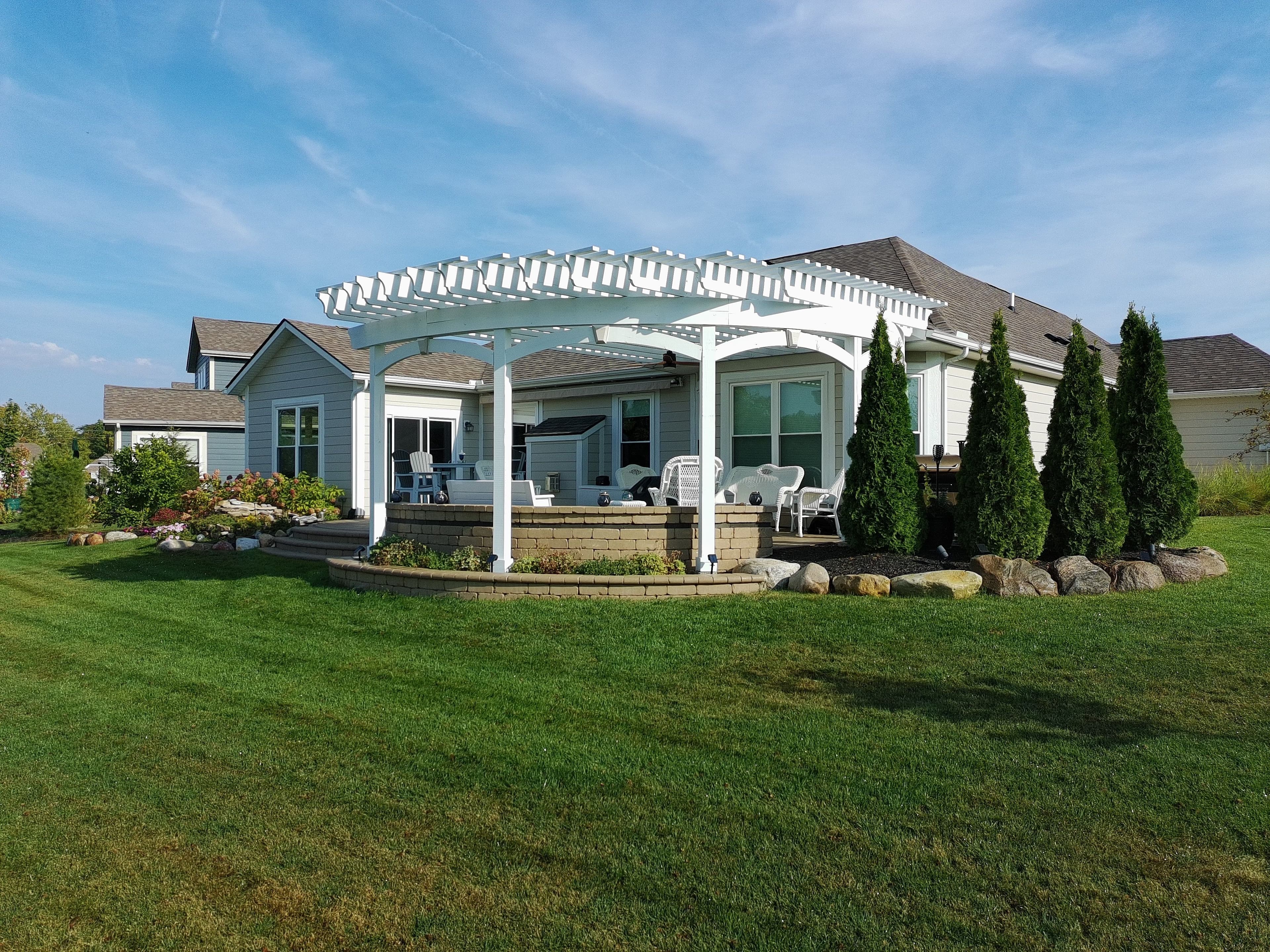 Custom white pergola with lattice detail and composite deck in Plainfield Indiana